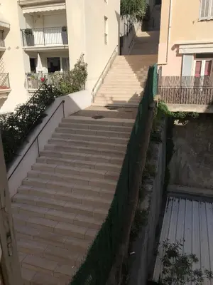 a set of stairs leading up to a building at 3 pièces- Vieux port- Terrasse - Parking Possible in Cannes