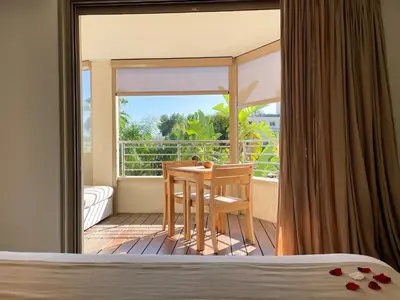 a bedroom with a table and chairs on a balcony at Cannes Villa St Barth in Cannes
