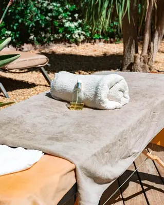 a towel sitting on top of a table with a glass at Cannes Villa St Barth in Cannes