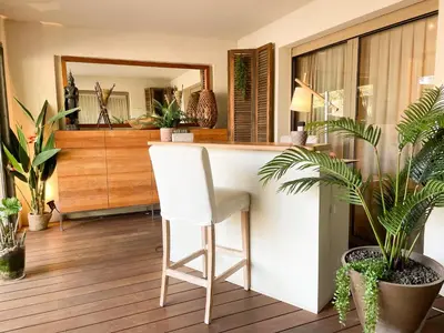 a white chair sitting at a counter in a room with plants at Cannes Villa St Barth in Cannes