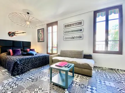 a bedroom with a bed and a couch and a table at #StudioCosy @ Center Cannes in Cannes