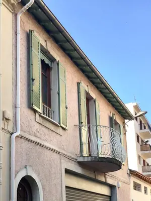 a building with green shuttered windows and a balcony at #StudioCosy @ Center Cannes in Cannes