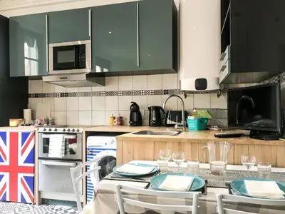 a kitchen with a table with chairs and a flag at #StudioCosy @ Center Cannes in Cannes