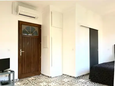 a bedroom with a door and a bed and a television at #StudioCosy @ Center Cannes in Cannes