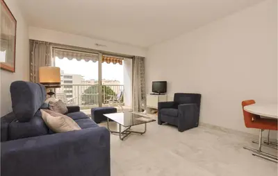 a living room with a couch and two chairs and a table at 1 Bedroom Lovely Apartment In Cannes in Cannes