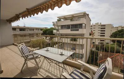 a balcony with a table and chairs and a building at 1 Bedroom Lovely Apartment In Cannes in Cannes