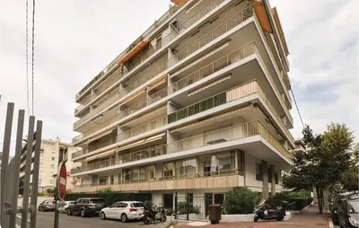 a tall building with cars parked in front of it at 1 Bedroom Lovely Apartment In Cannes in Cannes
