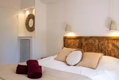 a white bed with two pillows on top of it at Place to beach - Bord de mer Croisette in Cannes