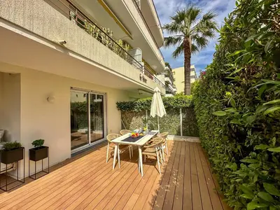 a wooden deck with a table and chairs on a house at Place to beach - Bord de mer Croisette in Cannes