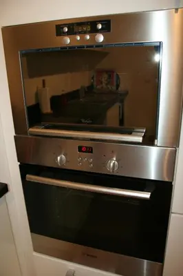 a stainless steel oven with a reflection in the window at Bristol Park - parking - 5mn walk from Palais des Festivals in Cannes