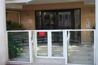 an entrance to a building with glass doors at Bristol Park - parking - 5mn walk from Palais des Festivals in Cannes