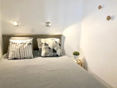 a bedroom with a bed with pillows on it at Cannes vue mer in Cannes