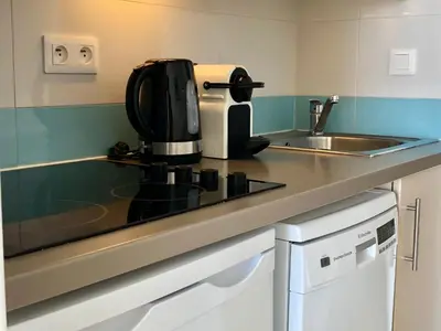 a kitchen counter with a coffee maker and a sink at Cannes vue mer in Cannes