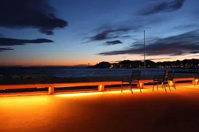 two chairs sitting on the beach at sunset at Cannes vue mer in Cannes