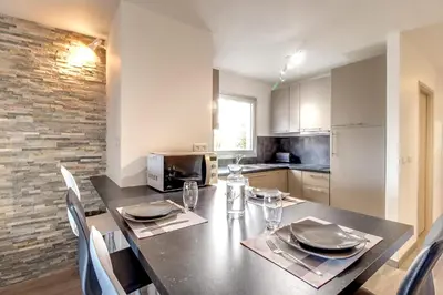 a kitchen with a table with plates and glasses on it at IMMOGROOM- Renovated - Wifi - Close to everything in Cannes