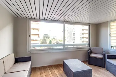 a living room with a couch and a large window at IMMOGROOM- Renovated - Wifi - Close to everything in Cannes