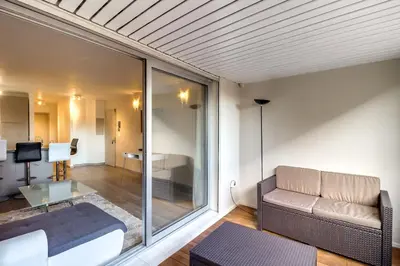a living room with a couch and a table at IMMOGROOM- Renovated - Wifi - Close to everything in Cannes