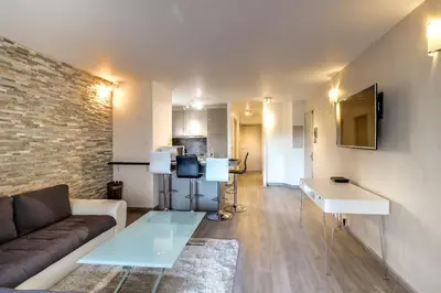 a living room with a couch and a table at IMMOGROOM- Renovated - Wifi - Close to everything in Cannes