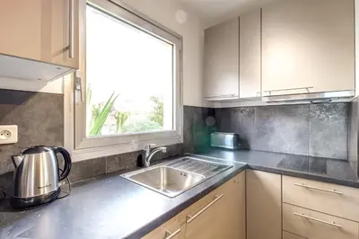 a kitchen with a sink and a window at IMMOGROOM- Renovated - Wifi - Close to everything in Cannes