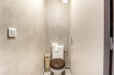 a bathroom with a brown toilet in a stall at IMMOGROOM- Renovated - Wifi - Close to everything in Cannes