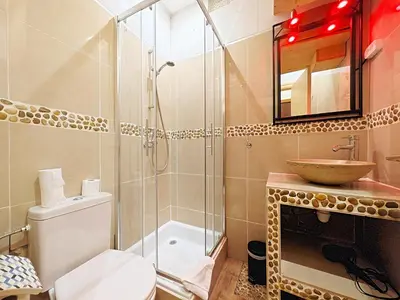a bathroom with a shower and a toilet and a sink at Viva Riviera - 19 rue des Frères Pradignac in Cannes