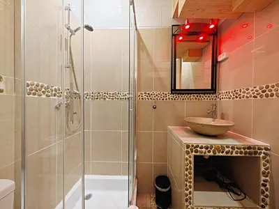 a bathroom with a sink and a glass shower at Viva Riviera - 19 rue des Frères Pradignac in Cannes