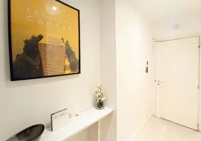 a white bathroom with a picture on the wall at Viva Riviera - 19 rue des Frères Pradignac in Cannes