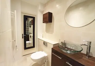 a bathroom with a sink and a toilet and a mirror at Viva Riviera - 19 rue des Frères Pradignac in Cannes