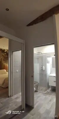 a room with a bathroom with a shower and a sink at La Petit Maison du Bonheur in Cannes