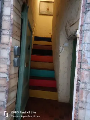 a hallway with a colorful staircase in a building at La Petit Maison du Bonheur in Cannes