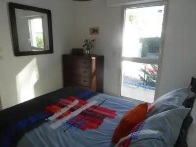 a bedroom with a bed and a dresser and a window at Modern one bedroomed apartment just off the Cannes Seafront with a terrace and pool access 1753 in Cannes
