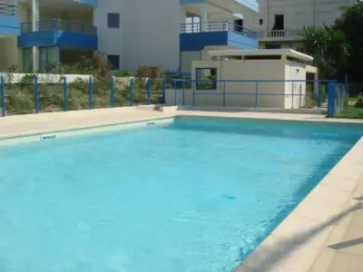 a large blue swimming pool in front of a building at Modern one bedroomed apartment just off the Cannes Seafront with a terrace and pool access 1753 in Cannes