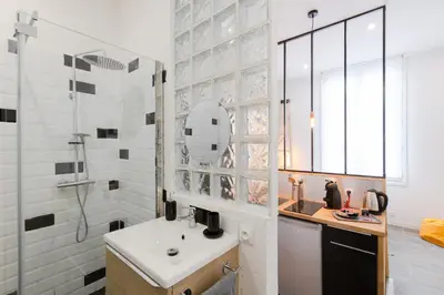 a bathroom with a sink and a shower with a mirror at Atelier & Galerie in Cannes