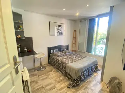 a bedroom with a bed and a large window at Atelier & Galerie in Cannes