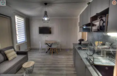 a kitchen and living room with a couch and a table at ALC - FF39 - 9 min Palais and Beaches in Cannes