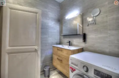 a bathroom with a sink and a washing machine at ALC - FF39 - 9 min Palais and Beaches in Cannes
