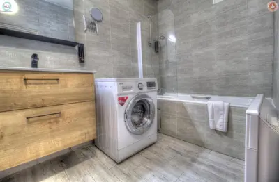 a bathroom with a washing machine and a bath tub at ALC - FF39 - 9 min Palais and Beaches in Cannes
