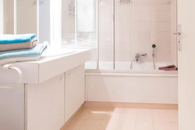 a white bathroom with a tub and a sink at Studio à deux pas du Palais des Festivals in Cannes