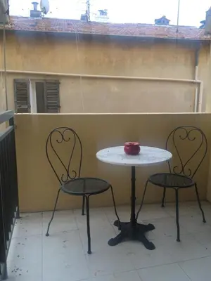 a table and two chairs in front of a wall at Studio à deux pas du Palais des Festivals in Cannes