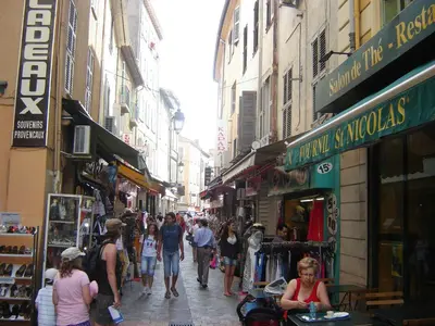 a group of people walking down a street with shops at Studio à deux pas du Palais des Festivals in Cannes