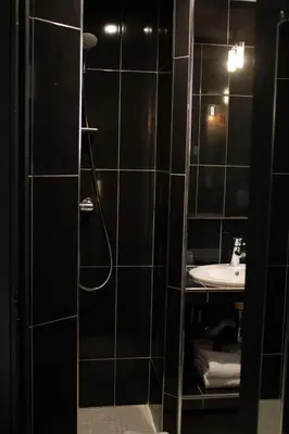 a bathroom with a shower and a sink at Hotel Molière in Cannes