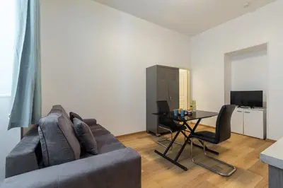 a living room with a couch and a table at Florella Marceau Apartment in Cannes