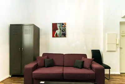 a living room with a couch and a painting on the wall at Florella Marceau Apartment in Cannes