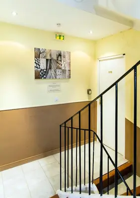 a staircase in a building with a sign on the wall at Florella Achard Apartment in Cannes