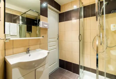 a bathroom with a sink and a shower at Florella Achard Apartment in Cannes