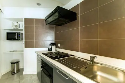 a kitchen with a sink and a stove at Florella Achard Apartment in Cannes