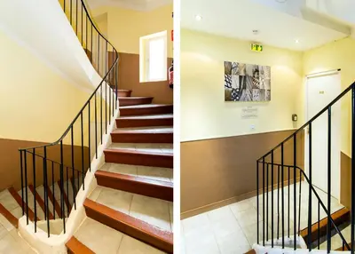 a staircase in a house with black railings at Florella Achard Apartment in Cannes