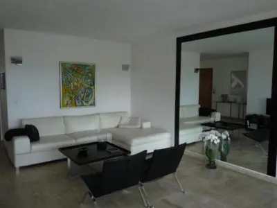 a living room with a white couch and a mirror at Two Bed apartment in a gated residence with gardens in Cannes with sea views 865 in Cannes