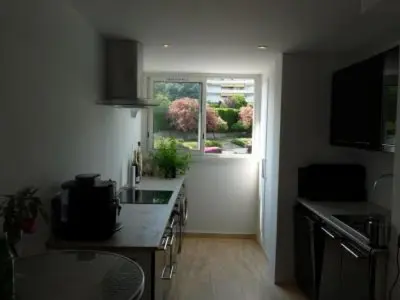 a kitchen with a sink and a window in it at Two Bed apartment in a gated residence with gardens in Cannes with sea views 865 in Cannes