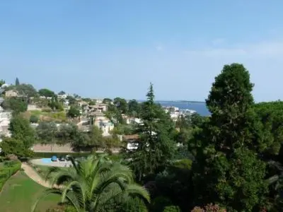 a view of a resort with trees and a pool at Two Bed apartment in a gated residence with gardens in Cannes with sea views 865 in Cannes
